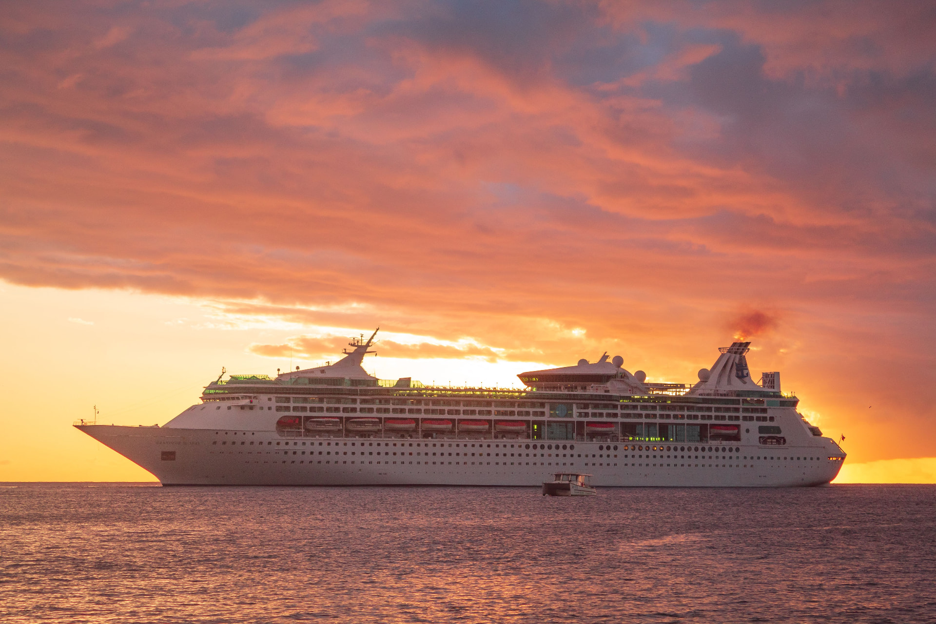 Cruise ship sailing at sunset