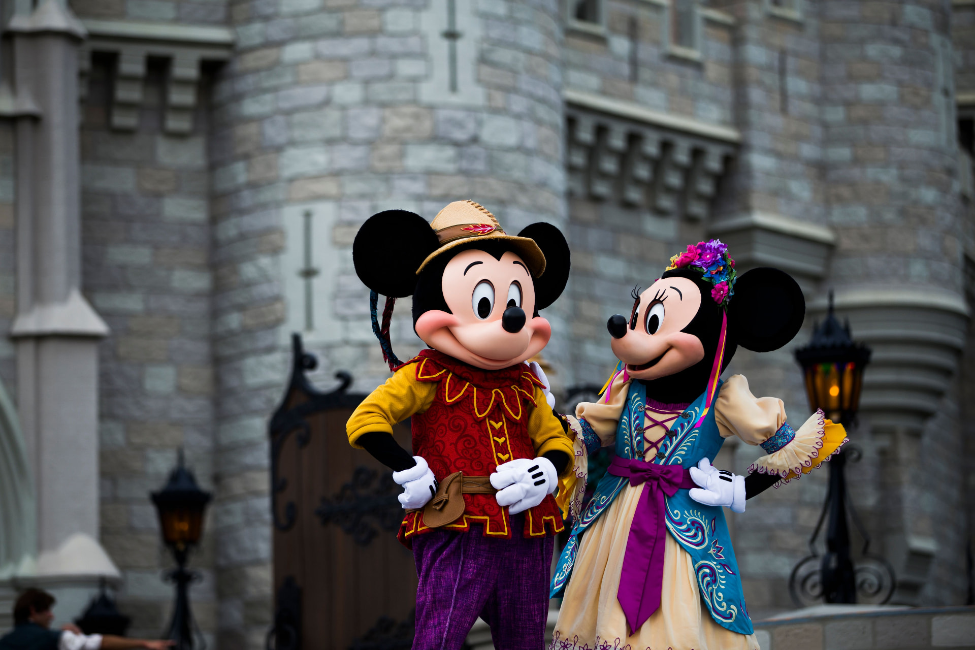 Mickey and Minnie Mouse outside a fairytale castle